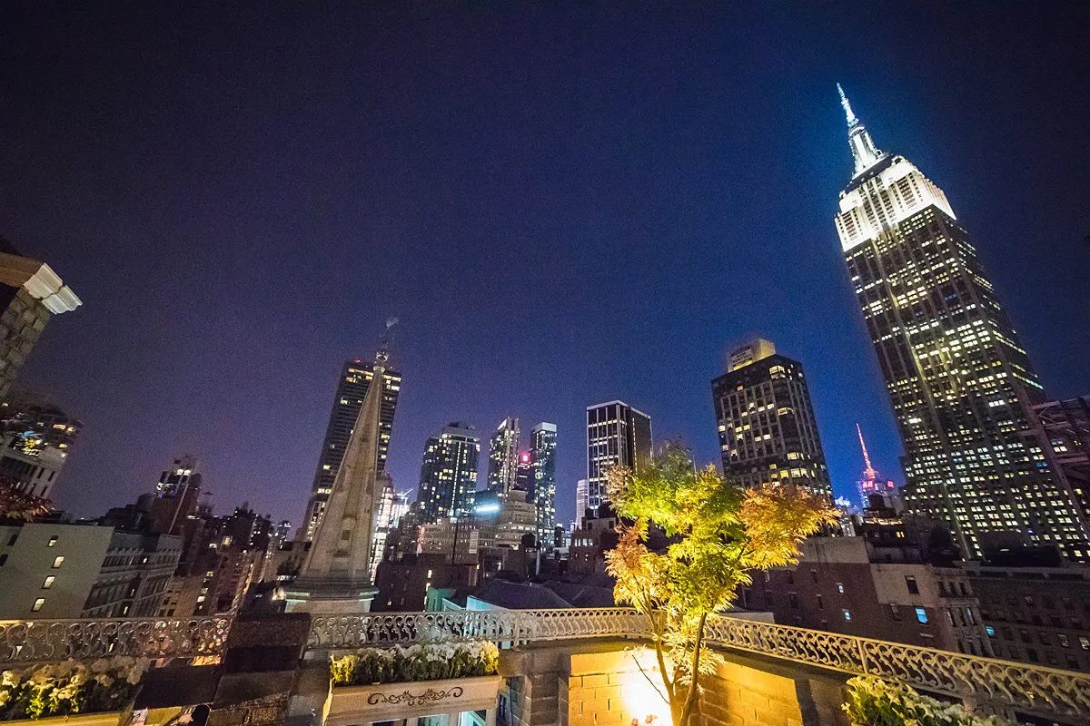 The Midtown Terrace at night, facing the illuminated Empire State Building