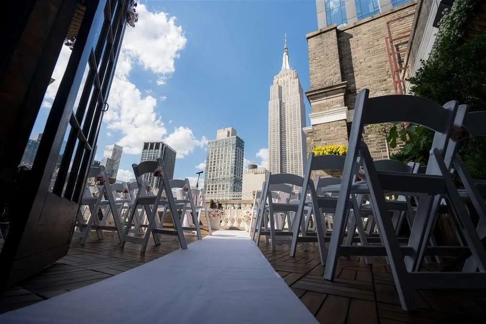 Looking down a ceremony aisle toward the Empire State Building